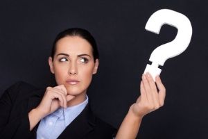 woman holding a question mark